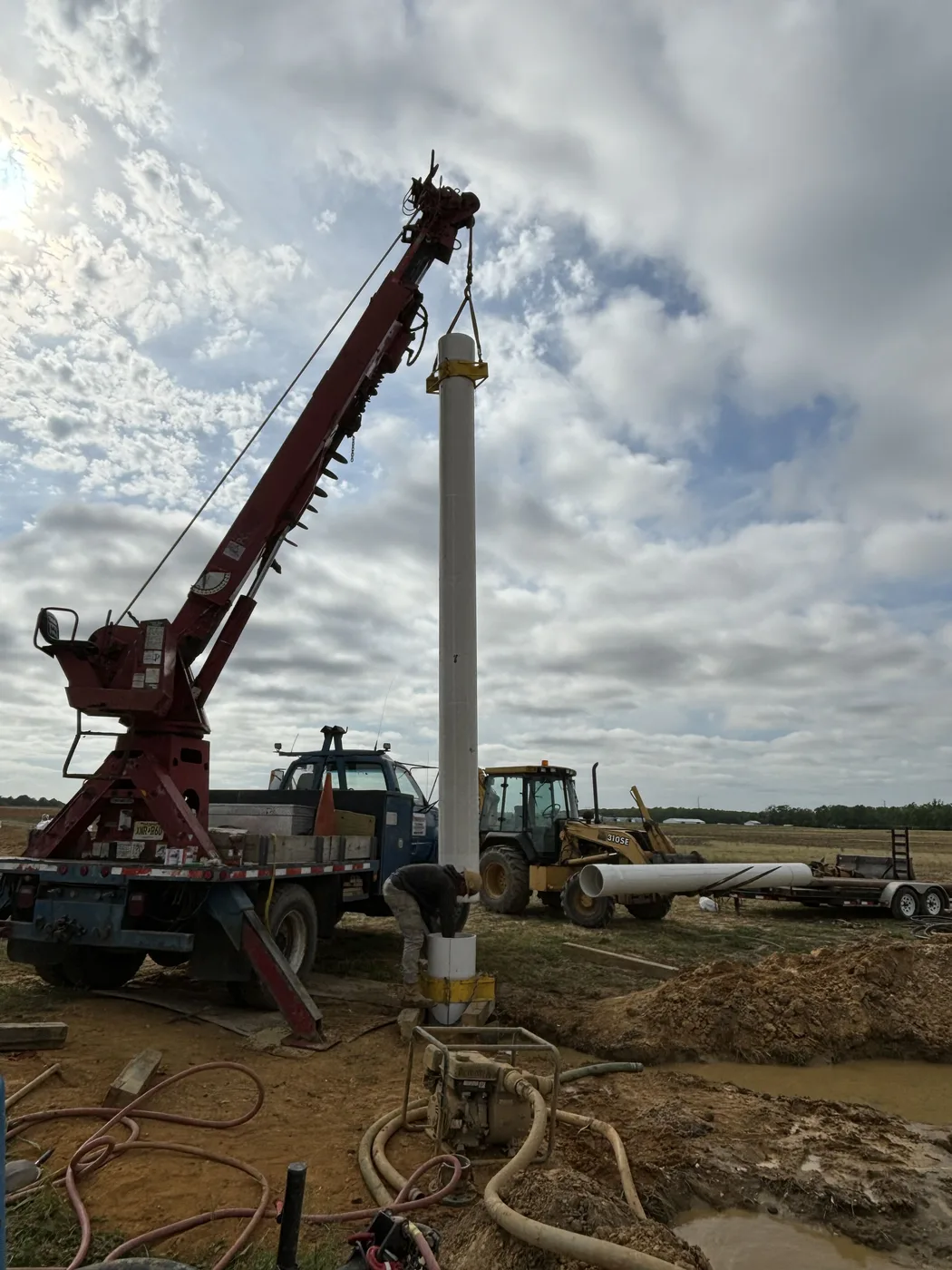 Crane standing well casing on a big bore job
